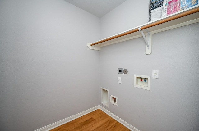 clothes washing area featuring laundry area, baseboards, hookup for a washing machine, light wood-style floors, and electric dryer hookup