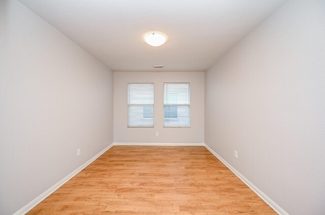 spare room featuring light hardwood / wood-style flooring