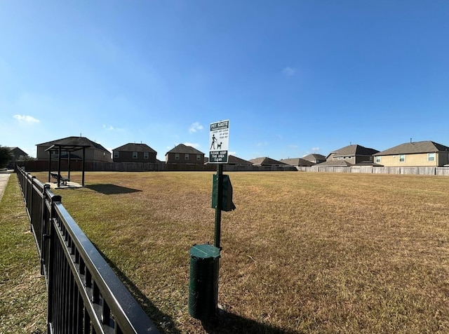 view of yard featuring a residential view and fence