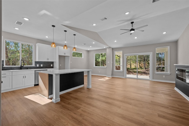 kitchen with white cabinetry, plenty of natural light, and a kitchen island