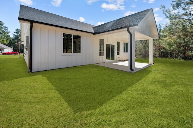 rear view of property featuring a yard and a patio