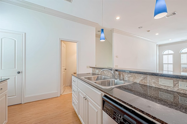 kitchen featuring pendant lighting, crown molding, sink, light wood-type flooring, and white cabinetry