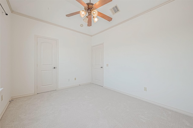 empty room featuring light carpet, crown molding, and ceiling fan