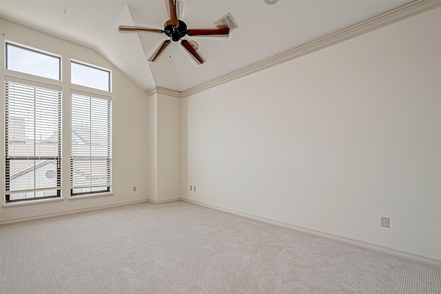 carpeted empty room featuring ceiling fan, vaulted ceiling, and ornamental molding