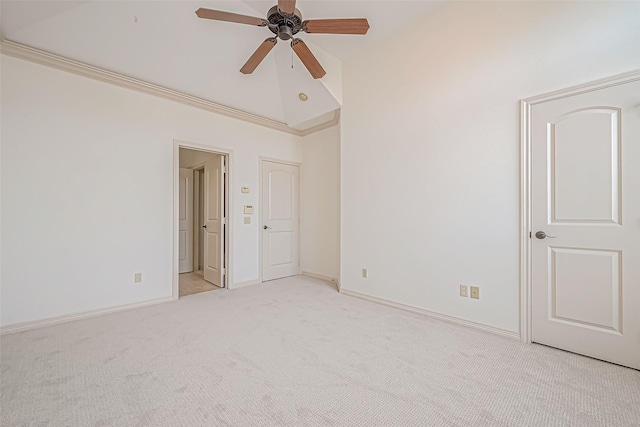 empty room featuring light carpet, crown molding, and ceiling fan