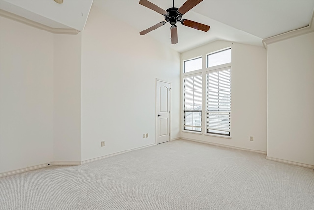 carpeted empty room with ceiling fan and vaulted ceiling