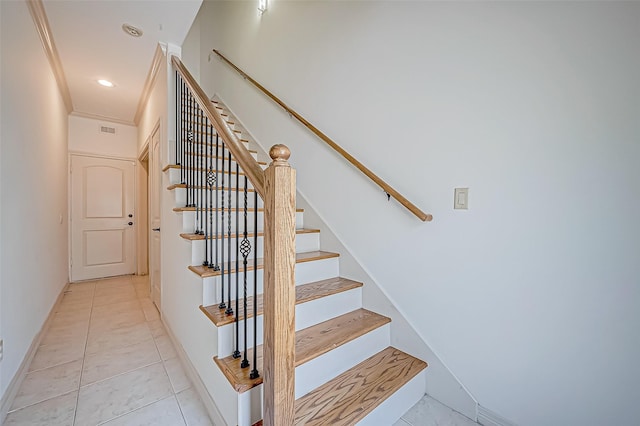 stairway with tile patterned flooring and ornamental molding