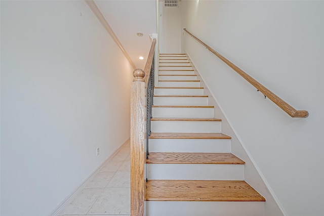 staircase featuring tile patterned floors