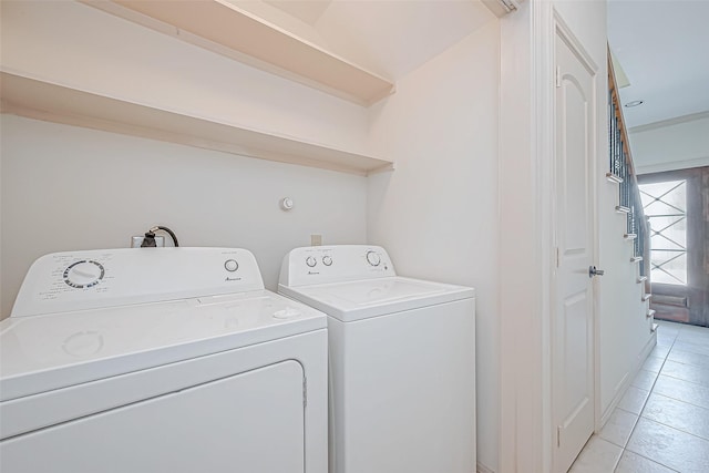 laundry room with light tile patterned floors and washing machine and clothes dryer