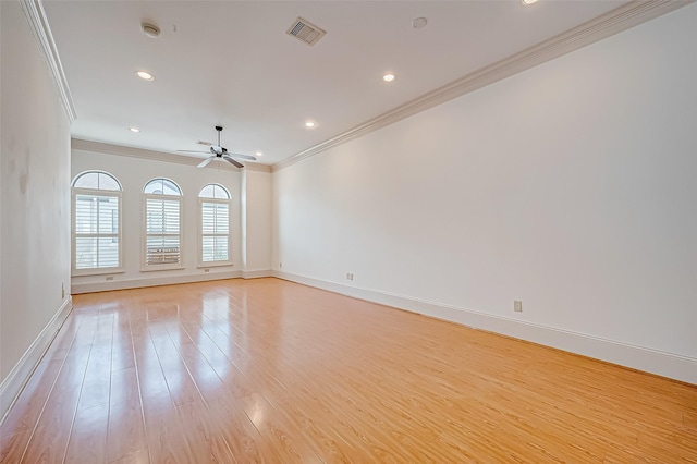 spare room with crown molding, ceiling fan, and light wood-type flooring