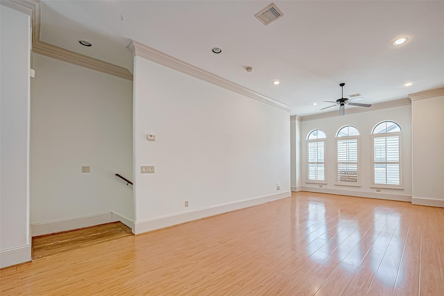 empty room featuring ceiling fan, light hardwood / wood-style flooring, and crown molding