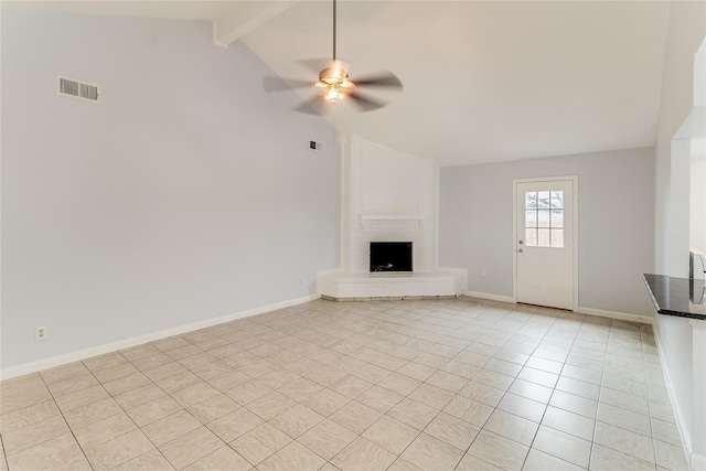 unfurnished living room with a large fireplace, vaulted ceiling with beams, ceiling fan, and light tile patterned floors