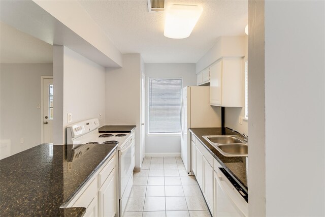 2530 Long Reach Dr, Sugar Land, TX 77478 - kitchen with white appliances, a sink, white cabinets, light tile patterned floors, and baseboards