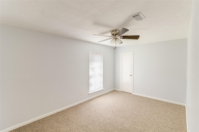 carpeted empty room with a textured ceiling and ceiling fan