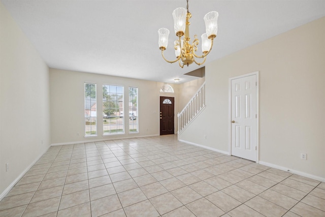 foyer with light tile patterned flooring and an inviting chandelier