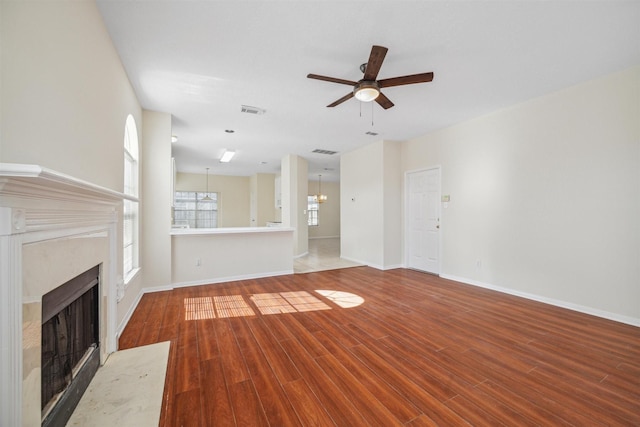 unfurnished living room featuring wood-type flooring and ceiling fan