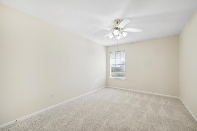 spare room with carpet floors and ceiling fan