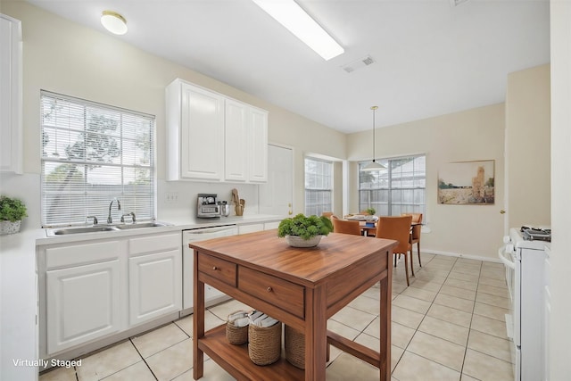 kitchen with white cabinetry, white appliances, sink, and a wealth of natural light