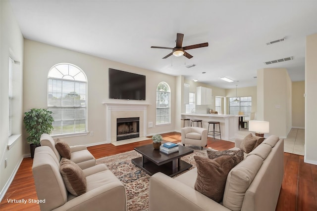 living room with ceiling fan and dark hardwood / wood-style floors