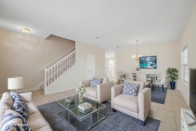 living room featuring an inviting chandelier and light tile patterned flooring