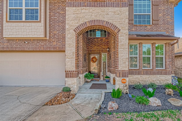 doorway to property with a garage