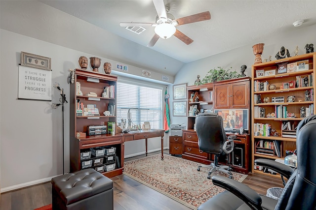 office area with ceiling fan, wood-type flooring, and vaulted ceiling