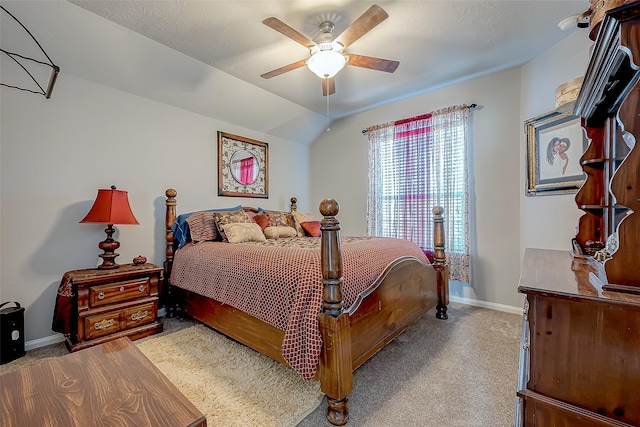 bedroom with ceiling fan, light colored carpet, and lofted ceiling