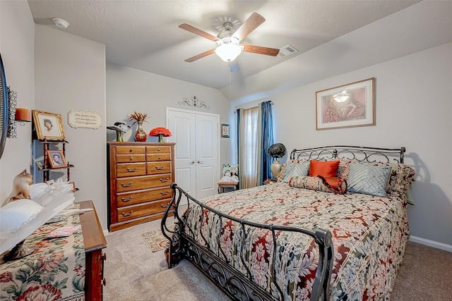 bedroom featuring ceiling fan, light colored carpet, and a closet