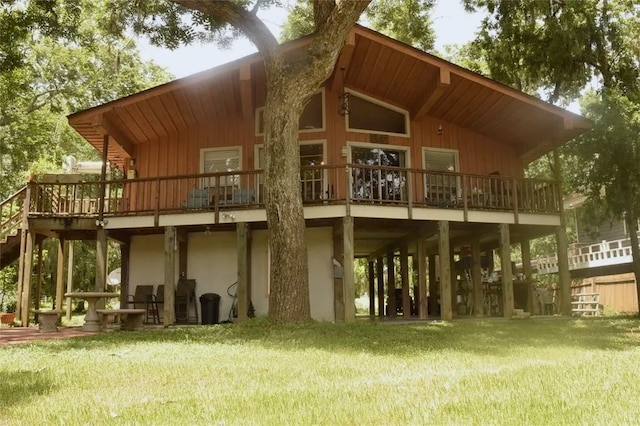 rear view of property with a yard and a wooden deck