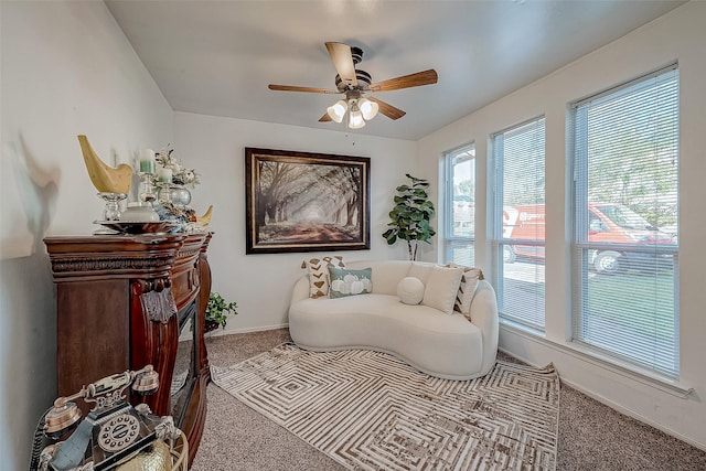 sitting room with carpet and ceiling fan