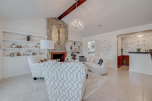 living room with vaulted ceiling with beams, built in shelves, light tile patterned floors, a fireplace, and a chandelier