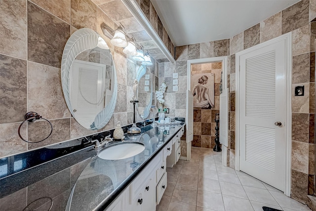 bathroom featuring tile patterned flooring, vanity, and tile walls