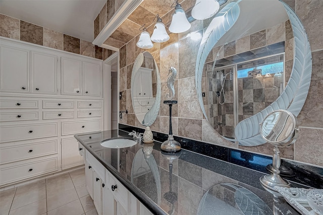 bathroom with tile patterned flooring, vanity, and tile walls