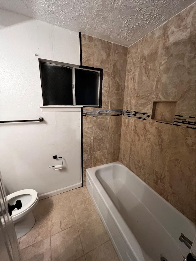 bathroom featuring tile patterned flooring, a bath, a textured ceiling, and toilet