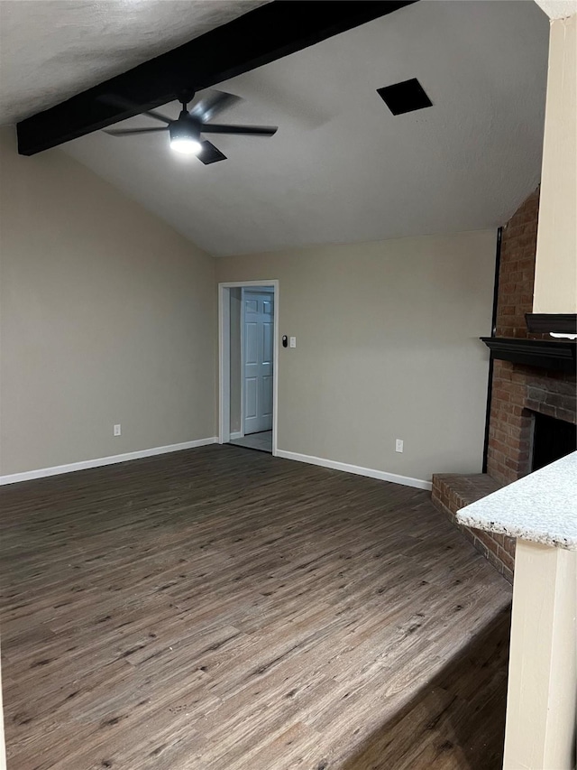 unfurnished living room featuring lofted ceiling with beams, ceiling fan, dark hardwood / wood-style flooring, and a fireplace