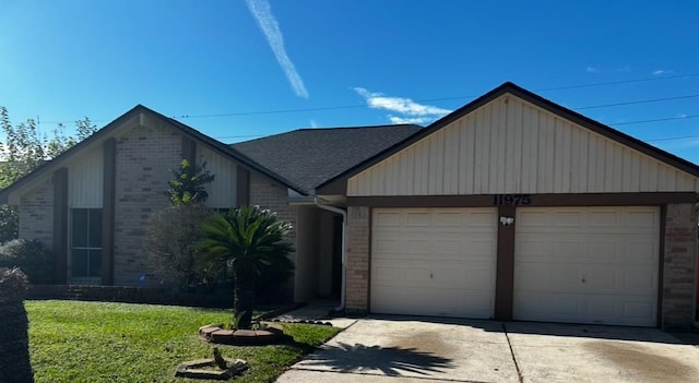 view of front of house with a front yard and a garage