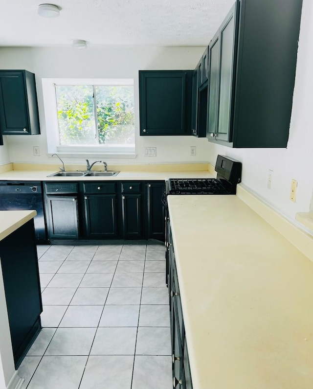 kitchen with sink, light tile patterned floors, and black dishwasher