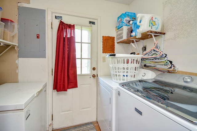 clothes washing area featuring separate washer and dryer and electric panel