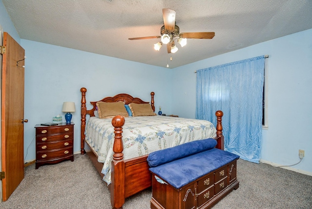 bedroom featuring a textured ceiling, light colored carpet, and ceiling fan