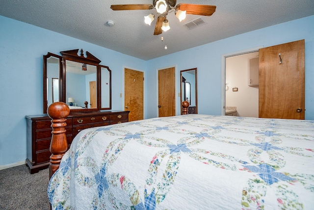 carpeted bedroom featuring ensuite bath, ceiling fan, and a textured ceiling