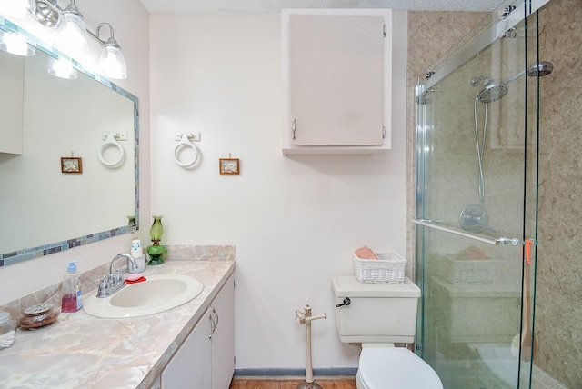 bathroom with walk in shower, vanity, a textured ceiling, and toilet