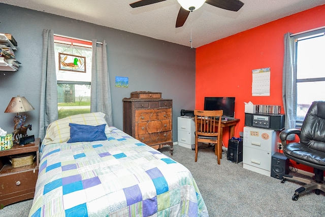 carpeted bedroom with a textured ceiling and ceiling fan