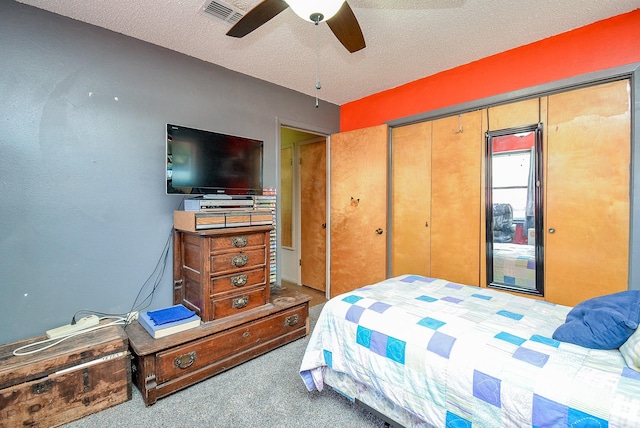 bedroom featuring ceiling fan, carpet floors, a textured ceiling, and a closet