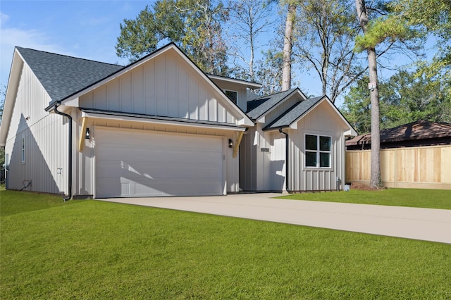 view of front of house with a front yard and a garage