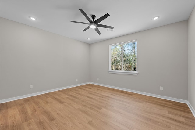 spare room with ceiling fan and light wood-type flooring