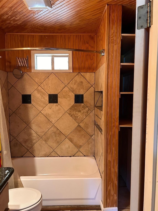 full bathroom with wood walls, toilet, and wooden ceiling