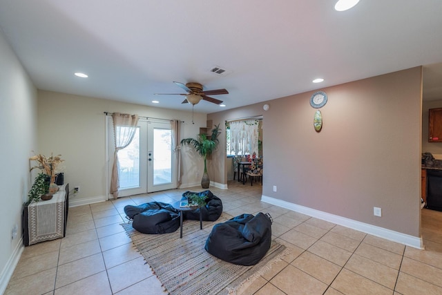 living room with french doors, light tile patterned floors, and ceiling fan