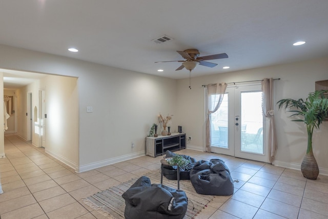 sitting room featuring ceiling fan, light tile patterned floors, and french doors