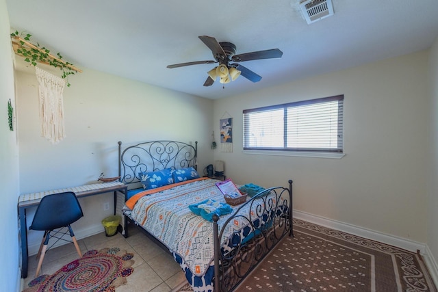 tiled bedroom featuring ceiling fan