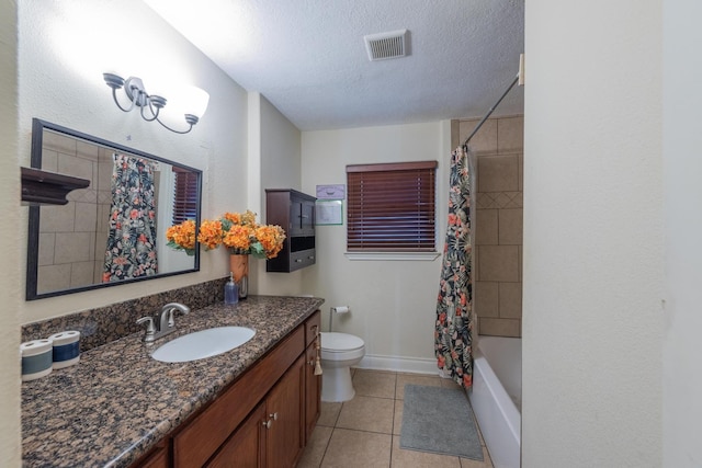 full bathroom featuring tile patterned floors, a textured ceiling, toilet, shower / bath combo with shower curtain, and vanity